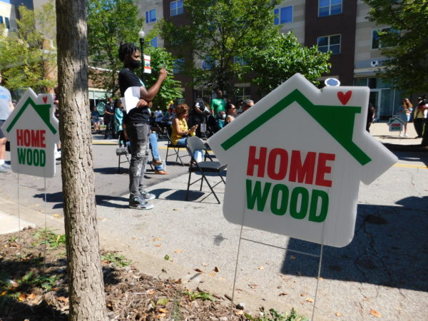 Picture of a lawn sign that says "Homewood" in the fashion of The Homewood Experience logo